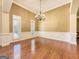Formal dining room with hardwood floors, wainscoting, and a chandelier at 211 English Oaks Ln, Mcdonough, GA 30253