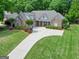 Beautiful brick home with a well-manicured lawn and a long driveway at 211 English Oaks Ln, Mcdonough, GA 30253