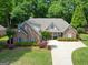 Aerial view of a beautiful brick home with a well-manicured lawn and inviting driveway at 211 English Oaks Ln, Mcdonough, GA 30253