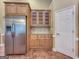 This kitchen features wooden cabinets, stainless steel refrigerator, and decorative tile backsplash at 211 English Oaks Ln, Mcdonough, GA 30253