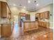 Spacious kitchen with wooden cabinetry, granite countertops, and an island at 211 English Oaks Ln, Mcdonough, GA 30253