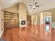 Bright living room featuring hardwood floors, fireplace, and an open layout at 211 English Oaks Ln, Mcdonough, GA 30253