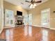 Bright living room features a fireplace, hardwood floors, high ceilings and shuttered windows at 211 English Oaks Ln, Mcdonough, GA 30253