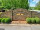Stone entrance to English Oaks subdivision with landscaped bushes at 211 English Oaks Ln, Mcdonough, GA 30253