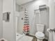 Bathroom featuring walk-in shower, gray and orange shower curtain, and soft white rug at 604 Magnolia Ln, Peachtree City, GA 30269