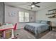 Bright bedroom with a ceiling fan, large windows, modern furniture, and neutral carpet at 604 Magnolia Ln, Peachtree City, GA 30269