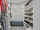Walk-in closet with custom shelving and a bench provides ample storage space for clothing and accessories at 604 Magnolia Ln, Peachtree City, GA 30269