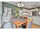 Dining area with decorative light fixture with view of kitchen with granite countertops and stainless appliances at 604 Magnolia Ln, Peachtree City, GA 30269