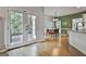 Bright dining area with double doors to deck and view into the kitchen with breakfast bar at 604 Magnolia Ln, Peachtree City, GA 30269