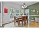 Dining area with large windows looking out to the yard for a light and airy feel with modern light fixture at 604 Magnolia Ln, Peachtree City, GA 30269