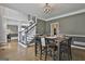 Elegant dining room featuring a modern chandelier and a stylish staircase at 604 Magnolia Ln, Peachtree City, GA 30269