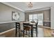 Dining room with gray accent wall, large windows, and hardwood floors for a warm, inviting atmosphere at 604 Magnolia Ln, Peachtree City, GA 30269