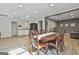 Open-concept dining room with wood-look flooring, a black refrigerator, gray walls, and a dining table at 604 Magnolia Ln, Peachtree City, GA 30269
