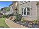 Stunning home entrance with stone steps, iron railings, and manicured landscaping at 604 Magnolia Ln, Peachtree City, GA 30269
