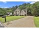 Inviting home with a long driveway, well-kept lawn, and mature trees at 604 Magnolia Ln, Peachtree City, GA 30269