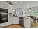 Bright kitchen with granite counters, sleek appliances, and an adjacent dining area at 604 Magnolia Ln, Peachtree City, GA 30269