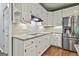 Well-lit kitchen with granite countertops, stainless steel appliances, and white cabinets at 604 Magnolia Ln, Peachtree City, GA 30269