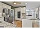 Open-concept kitchen featuring stainless steel appliances, granite countertops, and hardwood floors at 604 Magnolia Ln, Peachtree City, GA 30269