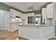 Modern kitchen featuring white cabinets, stainless steel appliances, granite countertops, and hardwood floors at 604 Magnolia Ln, Peachtree City, GA 30269