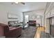 Bright living room featuring hardwood floors, a ceiling fan, and comfortable seating near a cozy fireplace at 604 Magnolia Ln, Peachtree City, GA 30269