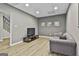Bright living room with wood floors, gray accent wall, TV and comfortable sofa at 604 Magnolia Ln, Peachtree City, GA 30269