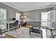 Stylish living room with a dedicated workspace, hardwood floors, and neutral-toned walls at 604 Magnolia Ln, Peachtree City, GA 30269