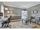 Inviting living room featuring hardwood floors, a stylish desk, and comfortable seating at 604 Magnolia Ln, Peachtree City, GA 30269