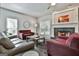 Spacious living room with fireplace, large windows, and plush seating perfect for relaxing and entertaining at 604 Magnolia Ln, Peachtree City, GA 30269