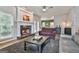 Comfortable living room with a cozy fireplace, hardwood floors, and views into the dining area at 604 Magnolia Ln, Peachtree City, GA 30269