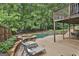 An outdoor patio offers a pool and spa with ample lounge seating and views of lush greenery at 604 Magnolia Ln, Peachtree City, GA 30269
