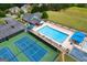 An aerial view showcasing a community pool, tennis courts, clubhouse, and parking, perfect for recreation and convenience at 6317 Benbrooke Nw Overlook, Acworth, GA 30101
