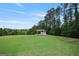 The property's vast, green backyard features a covered shelter on lush grass, perfect for recreation and relaxation at 6317 Benbrooke Nw Overlook, Acworth, GA 30101
