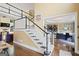 Staircase with black and white banisters leading up from the foyer, adjacent to the office at 6317 Benbrooke Nw Overlook, Acworth, GA 30101