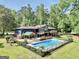 An aerial view of a home with a fenced pool, lush lawn, and ample privacy at 200 Camp Creek Trail, Peachtree City, GA 30269