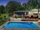 Aerial view of a home featuring a backyard pool and lovely landscaping at 200 Camp Creek Trail, Peachtree City, GA 30269