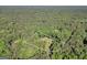 Beautiful aerial view outlines a property with a home and pool nestled in a wooded area at 200 Camp Creek Trail, Peachtree City, GA 30269
