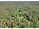 Aerial view showcases a 3.85-acre property with a home and pool surrounded by dense forest at 200 Camp Creek Trail, Peachtree City, GA 30269