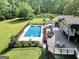 Spacious deck with patio seating overlooking a backyard pool with diving board at 200 Camp Creek Trail, Peachtree City, GA 30269