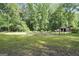 Expansive backyard with a fenced garden and a charming wooden shed at 200 Camp Creek Trail, Peachtree City, GA 30269