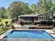 A backyard featuring a pool, patio, lush greenery and great landscaping at 200 Camp Creek Trail, Peachtree City, GA 30269