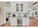 Elegant built-in bar area with granite countertop, cabinetry, and wine cooler at 200 Camp Creek Trail, Peachtree City, GA 30269