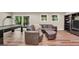 Finished basement with an air hockey table, leather couch, and sliding glass doors to the backyard at 200 Camp Creek Trail, Peachtree City, GA 30269