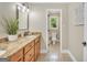 Bathroom featuring granite countertops, wood cabinets, and an attached toilet room at 200 Camp Creek Trail, Peachtree City, GA 30269