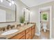 Bathroom featuring a double sink vanity, granite counters, wood cabinets, and natural light at 200 Camp Creek Trail, Peachtree City, GA 30269