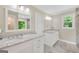 Bright bathroom featuring dual vanities with marble countertops, modern fixtures, and a neutral color palette at 200 Camp Creek Trail, Peachtree City, GA 30269