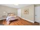 Bright bedroom with a vintage metal bed frame, hardwood floors, and natural light at 200 Camp Creek Trail, Peachtree City, GA 30269