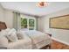 Cozy bedroom featuring a wooden sleigh bed, a large window, and hardwood floors at 200 Camp Creek Trail, Peachtree City, GA 30269