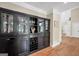 Hallway featuring elegant black built-in cabinets and shelving with crown molding at 200 Camp Creek Trail, Peachtree City, GA 30269