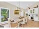 Bright dining area with hardwood floors, backyard views, and an elegant dining table and chairs at 200 Camp Creek Trail, Peachtree City, GA 30269