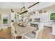 Dining area featuring an elegant dining table and chairs, hardwood floors, and bright windows with backyard views at 200 Camp Creek Trail, Peachtree City, GA 30269